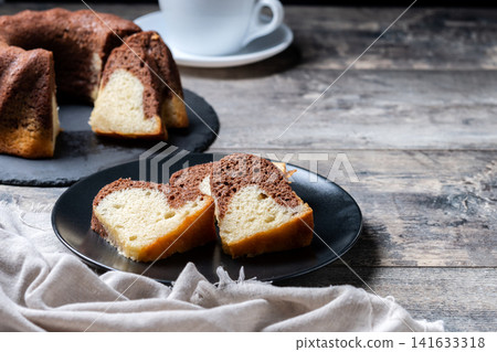 Marble bundt cake sliced on rustic wooden table Marble bundt cake sliced on rustic wooden table 141633318