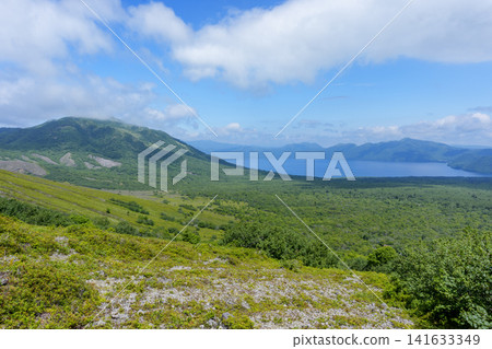 A spectacular panoramic view of Lake Shikotsu from the hiking trail of Mount Tarumae in Hokkaido. A spectacular panoramic view of Lake Shikotsu from the hiking trail of Mount Tarumae in Hokkaido. 141633349