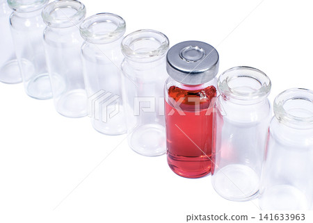 Phial with red vaccine in the row of empty vials Phial with red vaccine in the row of empty vials 141633963