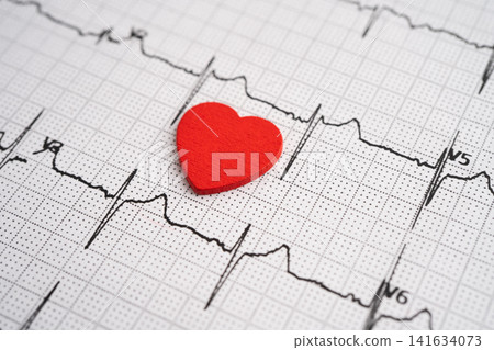 Red heart on electrocardiogram ECG with red heart, heart wave, heart attack, cardiogram report. Red heart on electrocardiogram ECG with red heart, heart wave, heart attack, cardiogram report. 141634073