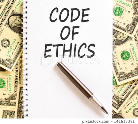 Code of ethics words symbol. Concept words Code of ethics on beautiful white note. Beautiful dollar bills background. Dollar bills. Business Code of ethics concept. Copy space. Code of ethics words symbol. Concept words Code of ethics on beautiful white note. Beautiful dollar bills background. Dollar bills. Business Code of ethics concept. Copy space. 141635351