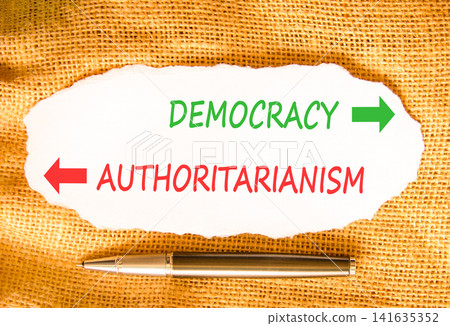 Democracy or authoritarianism words symbol. Concept words Democracy Authoritarianism on beautiful white paper. Beautiful canvas background. Business democracy authoritarianism concept. Copy space Democracy or authoritarianism words symbol. Concept words Democracy Authoritarianism on beautiful white paper. Beautiful canvas background. Business democracy authoritarianism concept. Copy space 141635352