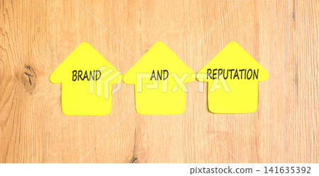 Brand and reputation words symbol. Concept words Brand and reputation on beautiful yellow paper houses. Beautiful wooden background. Business brand and reputation concept. Copy space. Brand and reputation words symbol. Concept words Brand and reputation on beautiful yellow paper houses. Beautiful wooden background. Business brand and reputation concept. Copy space. 141635392