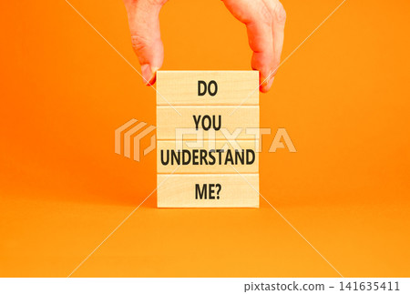 Do you understand me words symbol. Concept words Do you understand me on beautiful wooden blocks. Beautiful orange background. Businessman hand. Business Do you understand me concept. Copy space. Do you understand me words symbol. Concept words Do you understand me on beautiful wooden blocks. Beautiful orange background. Businessman hand. Business Do you understand me concept. Copy space. 141635411