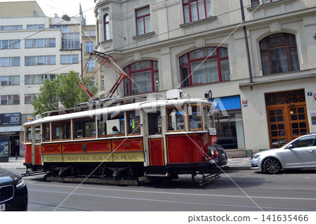Historic red tram on a city street in Prague for travel and urban transportation background banner Historic red tram on a city street in Prague for travel and urban transportation background banner 141635466