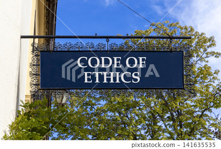 Code of ethics words symbol. Concept words Code of ethics on beautiful black road sign. Beautiful blue sky green tree background. Business Code of ethics concept. Copy space. 141635535