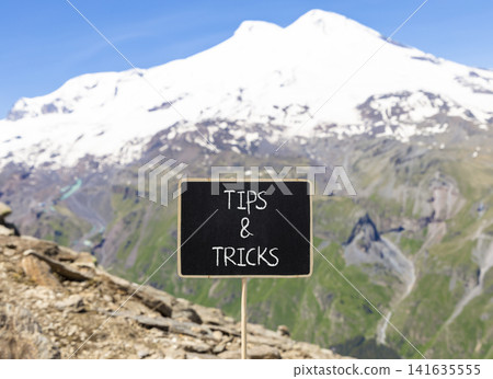 Tips and tricks words symbol. Concept words Tips and tricks on beautiful black blackboard. Beautiful mountain Elbrus sky background. Business tips and tricks motivational support concept. Copy space. Tips and tricks words symbol. Concept words Tips and tricks on beautiful black blackboard. Beautiful mountain Elbrus sky background. Business tips and tricks motivational support concept. Copy space. 141635555