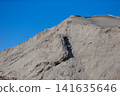 Desert mountain terrain showcasing dramatic rock formations under clear blue sky 141635646