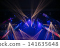 Colorful lights and beams enhance the vibrant atmosphere of a live performance at a concert venue 141635648