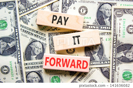 Pay it forward words symbol. Concept words Pay it forward on beautiful wooden blocks. Beautiful dollar bills background. Dollar bills. Business and pay it forward concept. Copy space. Pay it forward words symbol. Concept words Pay it forward on beautiful wooden blocks. Beautiful dollar bills background. Dollar bills. Business and pay it forward concept. Copy space. 141636082