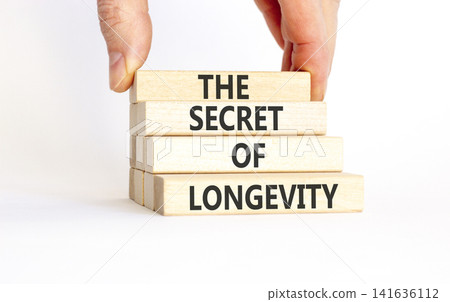 The secret of longevity words symbol. Concept words The secret of longevity on beautiful wooden blocks. Beautiful white background. Psychological medical the secret of longevity concept. Copy space. The secret of longevity words symbol. Concept words The secret of longevity on beautiful wooden blocks. Beautiful white background. Psychological medical the secret of longevity concept. Copy space. 141636112