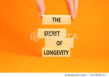 The secret of longevity words symbol. Concept words The secret of longevity on beautiful wooden blocks. Beautiful orange background. Psychological medical the secret of longevity concept. Copy space. The secret of longevity words symbol. Concept words The secret of longevity on beautiful wooden blocks. Beautiful orange background. Psychological medical the secret of longevity concept. Copy space. 141636117