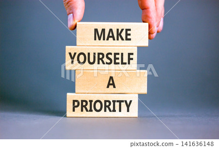 Make yourself a priority symbol. Concept words Make yourself a priority on beautiful wooden blocks. Beautiful grey background. Business psychological make yourself a priority concept. Copy space. Make yourself a priority symbol. Concept words Make yourself a priority on beautiful wooden blocks. Beautiful grey background. Business psychological make yourself a priority concept. Copy space. 141636148