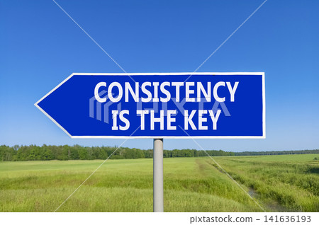 Consistency is the key symbol. Concept words Consistency is the key on beautiful blue road sign. Beautiful blue sky green field background. Business consistency is the key concept. Copy space. Consistency is the key symbol. Concept words Consistency is the key on beautiful blue road sign. Beautiful blue sky green field background. Business consistency is the key concept. Copy space. 141636193
