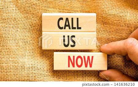 Call us now words symbol. Concept words Call us now on beautiful wooden blocks. Beautiful canvas background. Businessman hand. Business support motivational and call us now concept. Copy space. Call us now words symbol. Concept words Call us now on beautiful wooden blocks. Beautiful canvas background. Businessman hand. Business support motivational and call us now concept. Copy space. 141636210