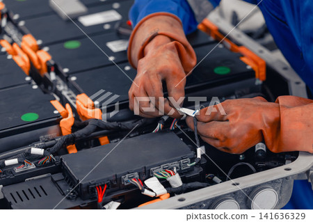 Professional EV Car Service, Male worker Electricity Vehicle Fix Maintenance EV Car Battery 141636329