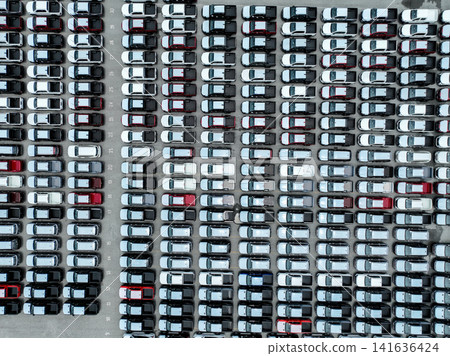 Aerial view vehicle assembly plant parking lot packed with cars, pickup truck, and SUV. Logistics, transportation strategy, electric and hybrid vehicle production. Trade agreements and tariffs. Aerial view vehicle assembly plant parking lot packed with cars, pickup truck, and SUV. Logistics, transportation strategy, electric and hybrid vehicle production. Trade agreements and tariffs. 141636424