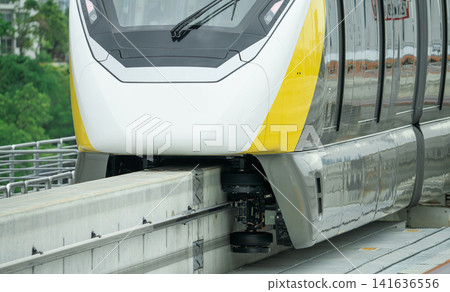 Elevated monorail train on rail. Guide wheels rubber tire on concrete guideway beam with conductor rail. Monorail technology. Modern mass transit. Rail transportation. Driverless straddle monorail. 141636556