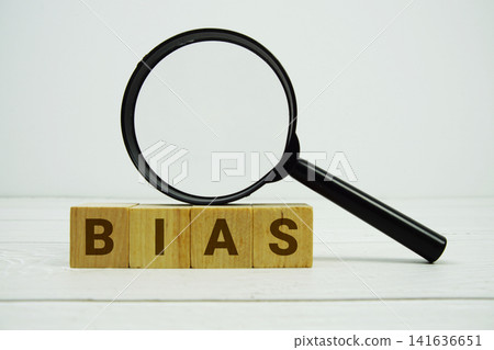 BIAS alphabet letters with magnifying glass on wooden background 141636651
