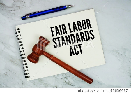Fair Labor Standards Act text written on notepad with pen and judge gavel on marble background 141636687