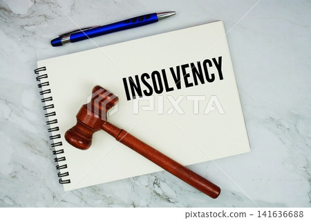Insolvency text written on notepad with pen and judge gavel on marble background Insolvency text written on notepad with pen and judge gavel on marble background 141636688