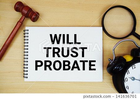 Will Trust Probate text written on notepad with pen, alarm clock and judge gavel on wooden background Will Trust Probate text written on notepad with pen, alarm clock and judge gavel on wooden background 141636701