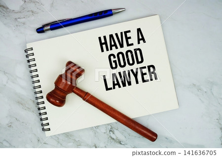 Have A Good Lawyer text written on notepad with pen and judge gavel on marble background Have A Good Lawyer text written on notepad with pen and judge gavel on marble background 141636705
