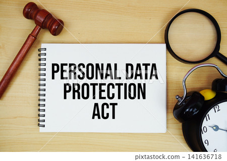 Personal Data Protection Act text written on notepad with pen, alarm clock and judge gavel on wooden background Personal Data Protection Act text written on notepad with pen, alarm clock and judge gavel on wooden background 141636718