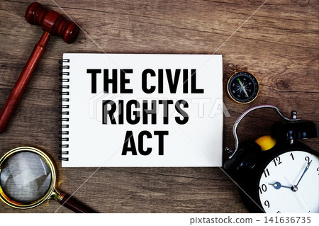 The Civil Rights Act message written on notepad with alarm clock, wood gavel and magnifying glass flat lay on wooden background The Civil Rights Act message written on notepad with alarm clock, wood gavel and magnifying glass flat lay on wooden background 141636735
