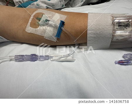 Intravenous catheter placed in the forearm of a hospitalized patient Intravenous catheter placed in the forearm of a hospitalized patient 141636758