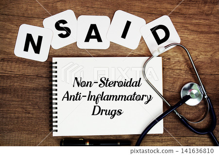 NSAID Non-Steroidal Anti-Inflammatory Drugs text written on notepad with stethoscope on wooden background NSAID Non-Steroidal Anti-Inflammatory Drugs text written on notepad with stethoscope on wooden background 141636810