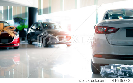 Rearview car parked in luxury showroom. Car dealership office. New car parked in modern showroom. Car for sale and rent business concept. Automobile leasing and insurance concept. Electric automobile. Rearview car parked in luxury showroom. Car dealership office. New car parked in modern showroom. Car for sale and rent business concept. Automobile leasing and insurance concept. Electric automobile. 141636880