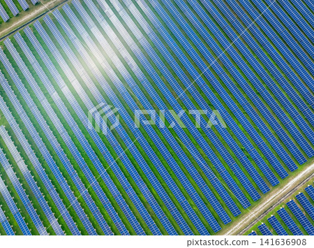 Aerial view of solar farm. Solar power for green energy. Sustainable resources. Solar cell panels use sun light as a source to generate electricity. Photovoltaics or PV. Sustainable renewable energy. Aerial view of solar farm. Solar power for green energy. Sustainable resources. Solar cell panels use sun light as a source to generate electricity. Photovoltaics or PV. Sustainable renewable energy. 141636908