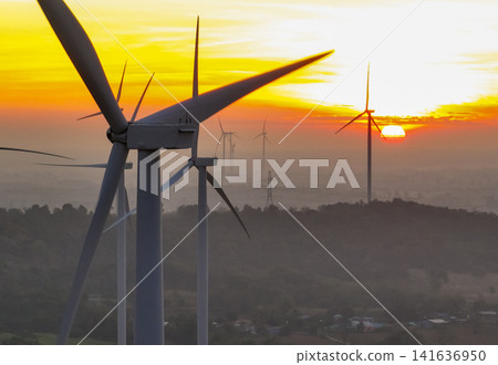 Wind farm field and sunset sky. Wind power. Sustainable, renewable energy. Wind turbines generate electricity. Sustainable development. Green technology for energy sustainability. Eco-friendly energy. Wind farm field and sunset sky. Wind power. Sustainable, renewable energy. Wind turbines generate electricity. Sustainable development. Green technology for energy sustainability. Eco-friendly energy. 141636950