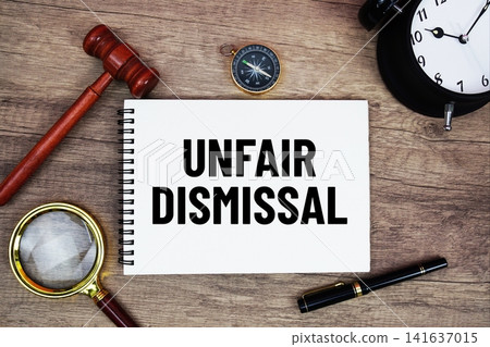 Unfair Dismissal message written on notepad with alarm clock, wood gavel and magnifying glass flat lay on wooden background Unfair Dismissal message written on notepad with alarm clock, wood gavel and magnifying glass flat lay on wooden background 141637015