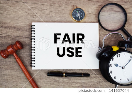Fair Use message written on notepad with alarm clock, wood gavel and magnifying glass flat lay on wooden background Fair Use message written on notepad with alarm clock, wood gavel and magnifying glass flat lay on wooden background 141637044