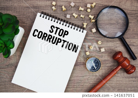 Stop Corruption message written on notepad with wood gavel and magnifying glass flat lay on wooden background Stop Corruption message written on notepad with wood gavel and magnifying glass flat lay on wooden background 141637051
