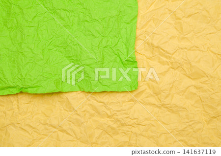 crumpled green and yellow paper lies in layers close up crumpled green and yellow paper lies in layers close up 141637119