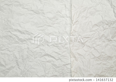 two layers of crumpled white paper forming vertical joint line on background two layers of crumpled white paper forming vertical joint line on background 141637132