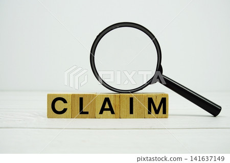 CLAIM alphabet letters with magnifying glass on wooden background CLAIM alphabet letters with magnifying glass on wooden background 141637149