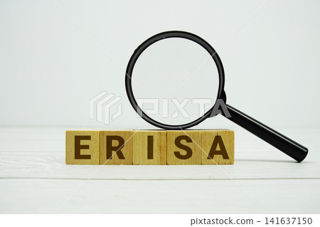 ERISA Employee Retirement Income Security Act alphabet letters with magnifying glass on wooden background ERISA Employee Retirement Income Security Act alphabet letters with magnifying glass on wooden background 141637150