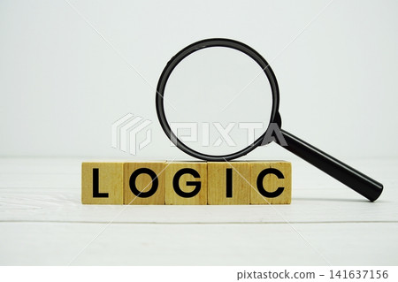 LOGIC alphabet letters with magnifying glass on wooden background LOGIC alphabet letters with magnifying glass on wooden background 141637156