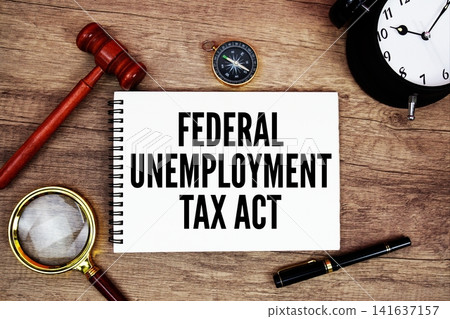 FUTA Federal Unemployment Tax Act message written on notepad with alarm clock, wood gavel and magnifying glass flat lay on wooden background FUTA Federal Unemployment Tax Act message written on notepad with alarm clock, wood gavel and magnifying glass flat lay on wooden background 141637157