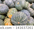 A pile of green kabocha squash pumpkins at a market. 141637261