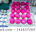 Bright pink dyed eggs in a cardboard carton on display at a market - 07.05.2026, Auburn WA, USA. 141637269
