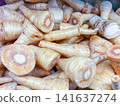 Fresh parsnip root vegetables piled together, showing cut cross-sections 141637274