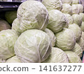 Stack of fresh green cabbages on display in a grocery store produce section 141637277