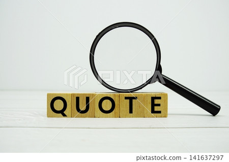 QUOTE alphabet letters with magnifying glass on wooden background QUOTE alphabet letters with magnifying glass on wooden background 141637297