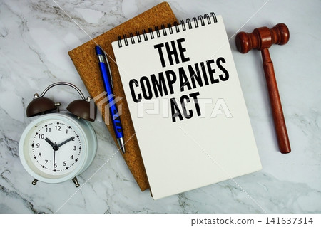 The Companies Act text written on notepad with pen, alarm clock and judge gavel on marble background The Companies Act text written on notepad with pen, alarm clock and judge gavel on marble background 141637314