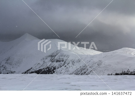 Winter mountain view in Carpathian mountains with dramatic clouds Winter mountain view in Carpathian mountains with dramatic clouds 141637472
